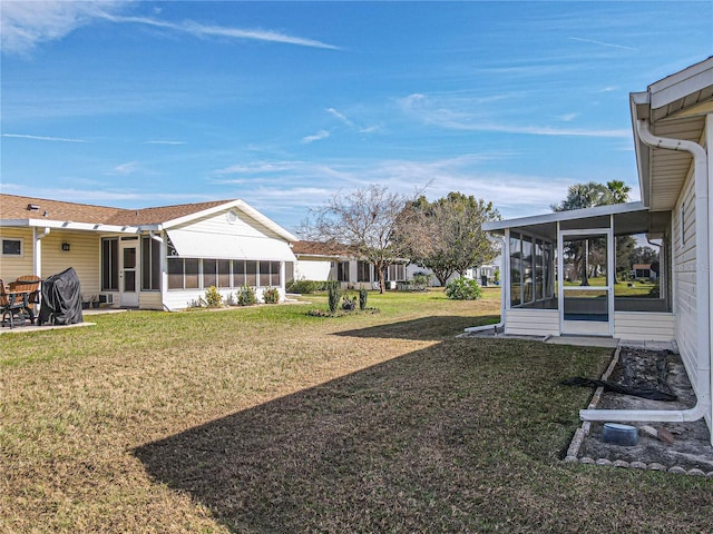 view of yard featuring a sunroom