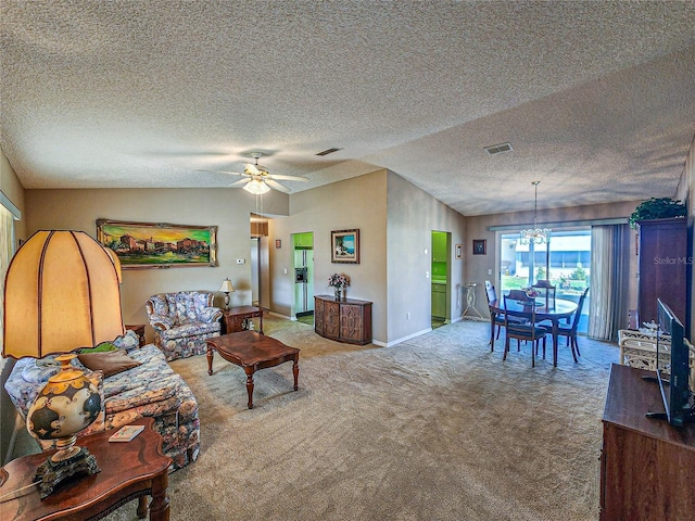 carpeted living room with ceiling fan with notable chandelier and lofted ceiling