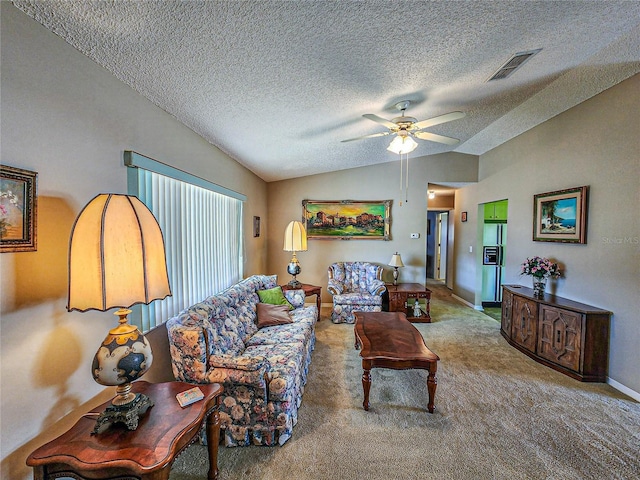 carpeted living room with a textured ceiling, vaulted ceiling, and ceiling fan