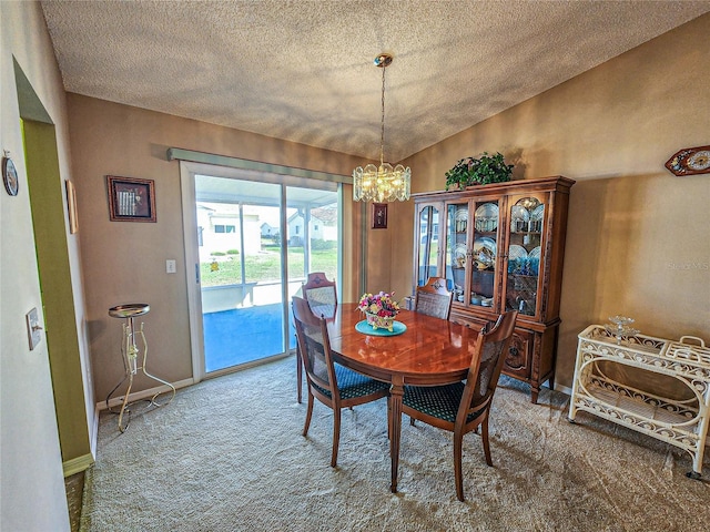 carpeted dining room with lofted ceiling and a notable chandelier