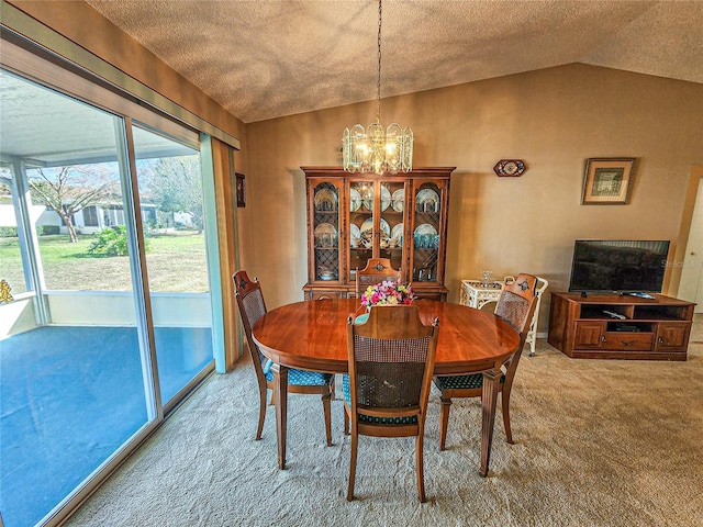 carpeted dining space with lofted ceiling and a notable chandelier