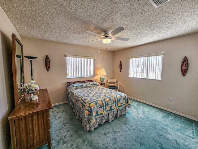 bedroom featuring ceiling fan, carpet, and a textured ceiling