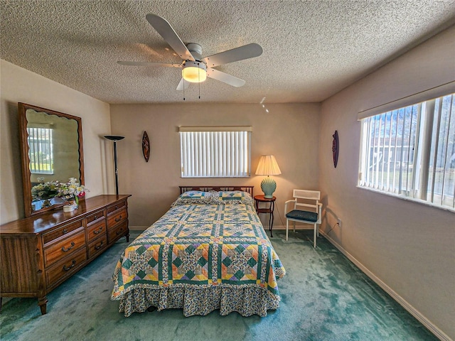 carpeted bedroom featuring ceiling fan and a textured ceiling