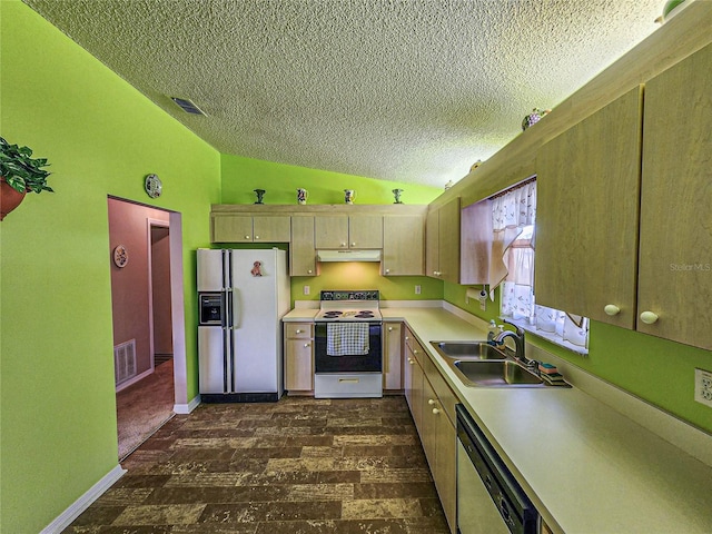 kitchen featuring white appliances, sink, vaulted ceiling, a textured ceiling, and dark hardwood / wood-style flooring