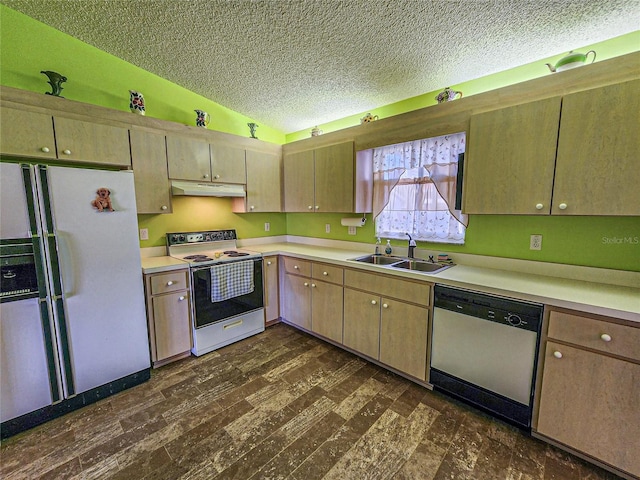 kitchen with dark hardwood / wood-style flooring, white appliances, sink, and vaulted ceiling