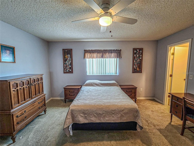 carpeted bedroom with a textured ceiling and ceiling fan