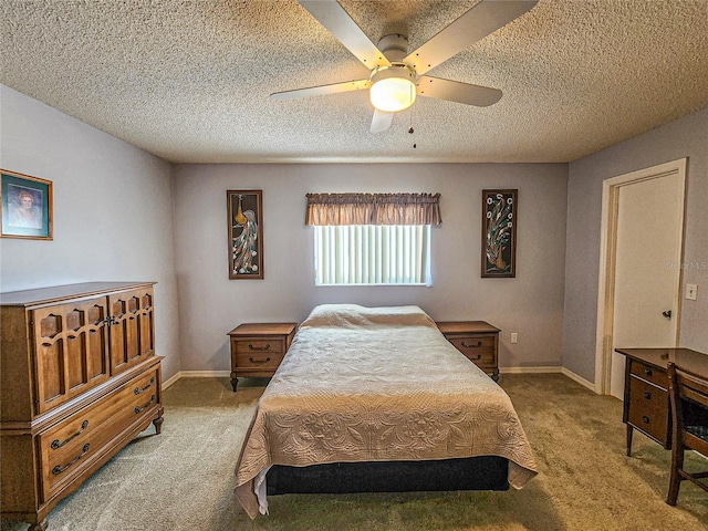 carpeted bedroom featuring ceiling fan and a textured ceiling