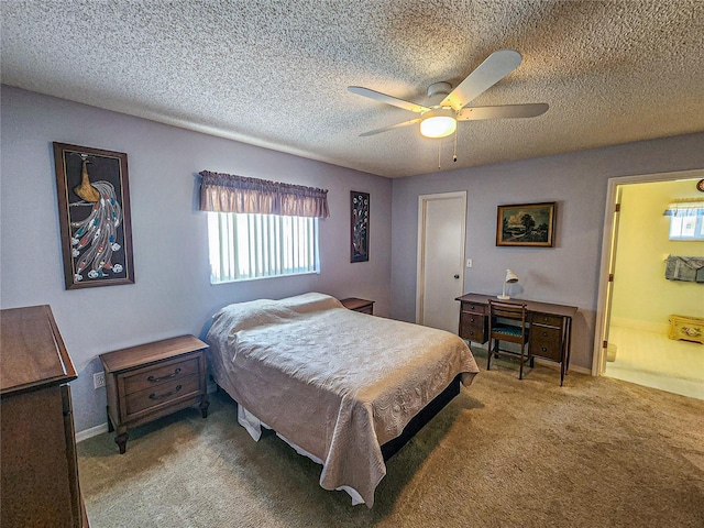 carpeted bedroom with ceiling fan, ensuite bathroom, and a textured ceiling