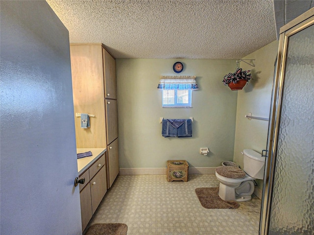 bathroom featuring a textured ceiling, vanity, toilet, and an enclosed shower