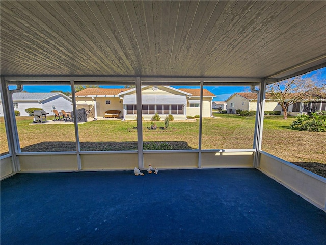 unfurnished sunroom with wooden ceiling