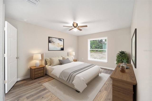 bedroom with wood-type flooring and ceiling fan