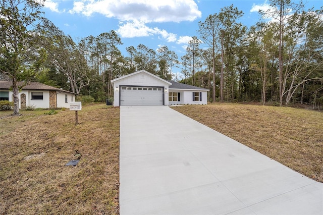 ranch-style home featuring a garage and a front lawn