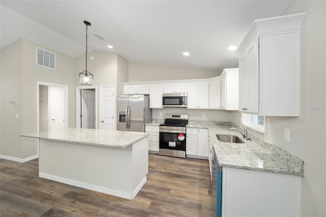 kitchen featuring sink, white cabinetry, hanging light fixtures, a kitchen island, and stainless steel appliances