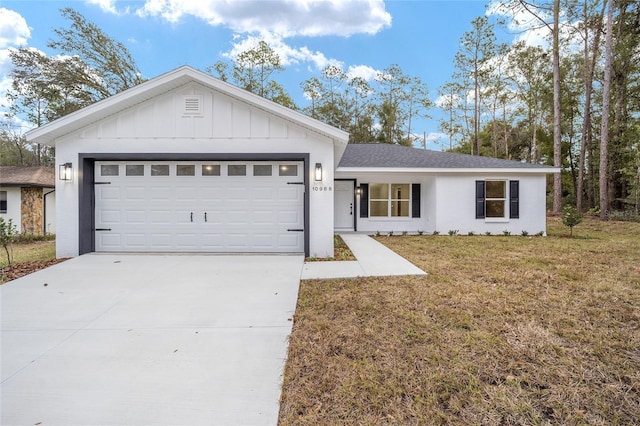 ranch-style house with a garage and a front lawn