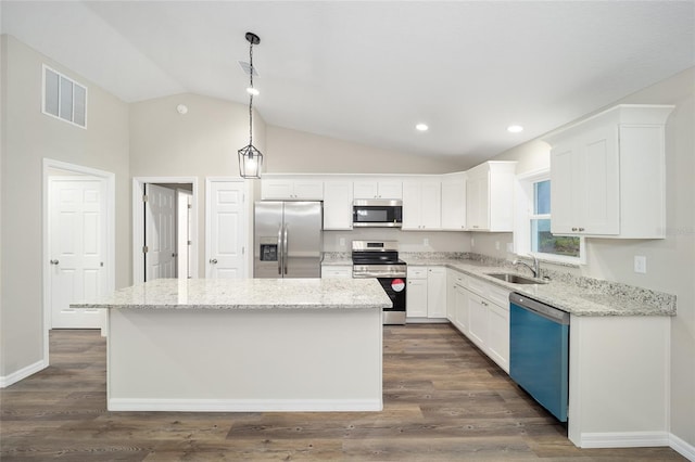 kitchen with a kitchen island, white cabinetry, sink, hanging light fixtures, and stainless steel appliances