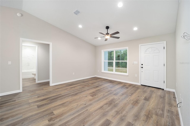 interior space featuring ceiling fan, lofted ceiling, and dark hardwood / wood-style flooring