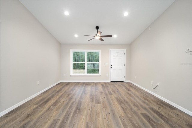 unfurnished room featuring ceiling fan and dark hardwood / wood-style flooring