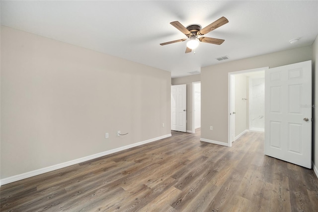 interior space with dark wood-type flooring and ceiling fan