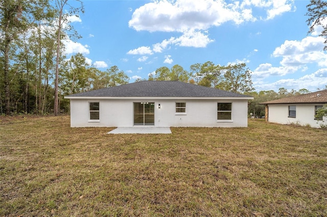 back of property featuring a patio and a yard