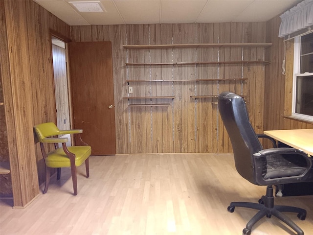 office space featuring wooden walls and light hardwood / wood-style floors