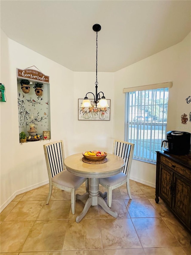 tiled dining room with an inviting chandelier