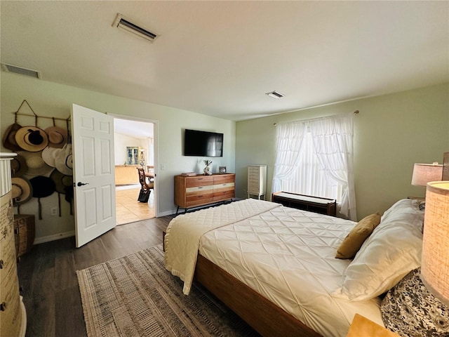 bedroom with dark hardwood / wood-style flooring