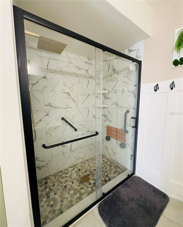 bathroom with tile patterned floors and an enclosed shower