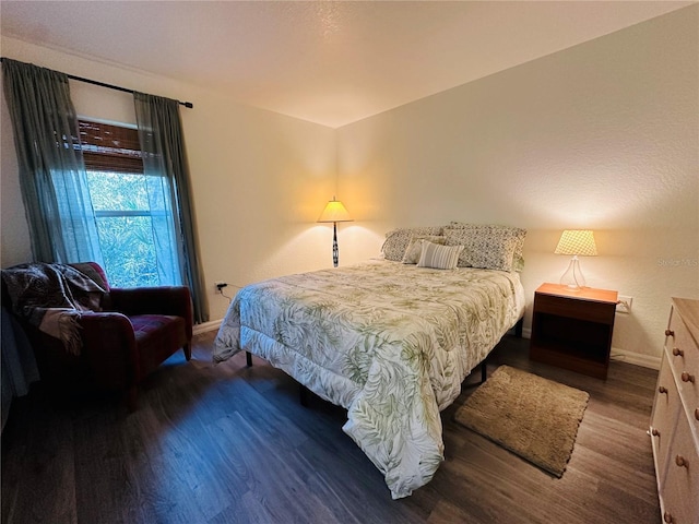 bedroom with dark wood-type flooring