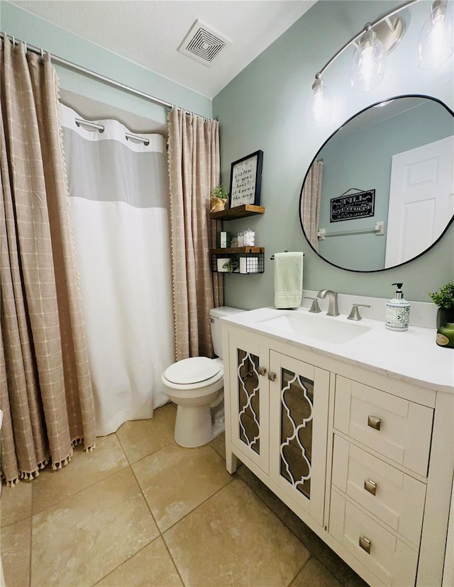 bathroom with tile patterned floors, vanity, and toilet