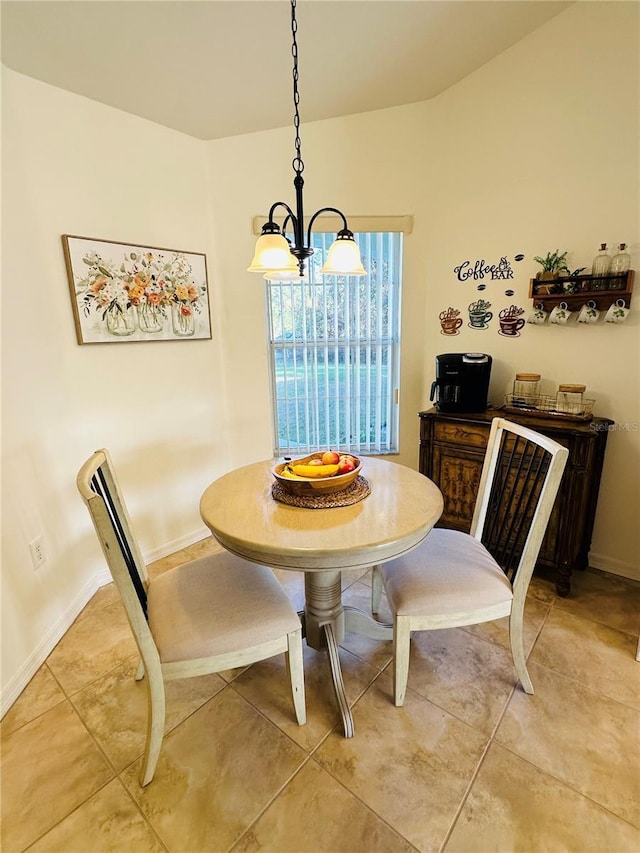 dining space featuring light tile patterned floors and an inviting chandelier