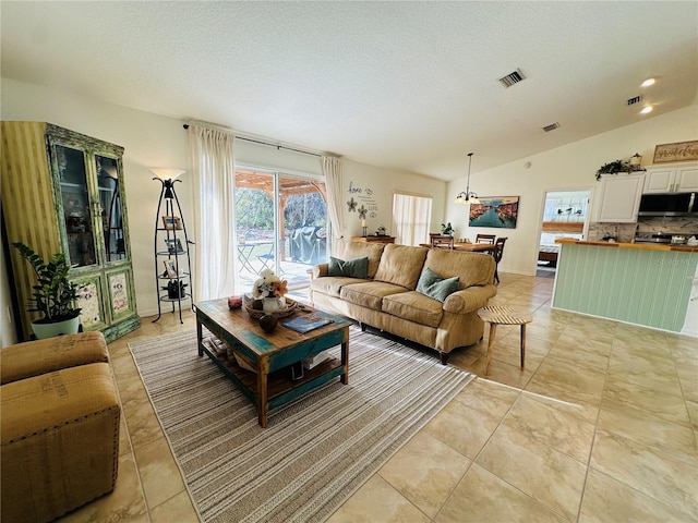 tiled living room featuring a textured ceiling and vaulted ceiling