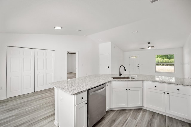 kitchen with lofted ceiling, sink, stainless steel dishwasher, ceiling fan, and white cabinetry