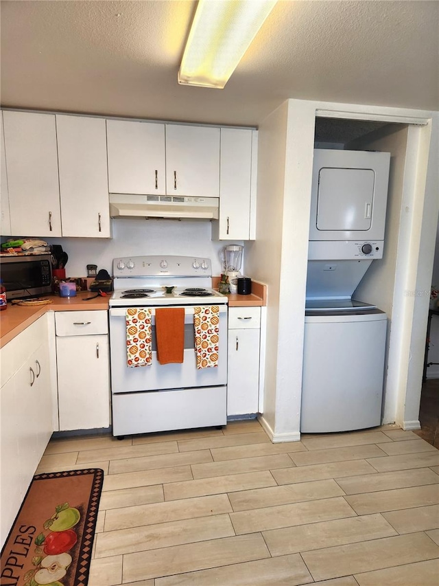 kitchen with white range with electric stovetop, stacked washer and dryer, white cabinets, and a textured ceiling