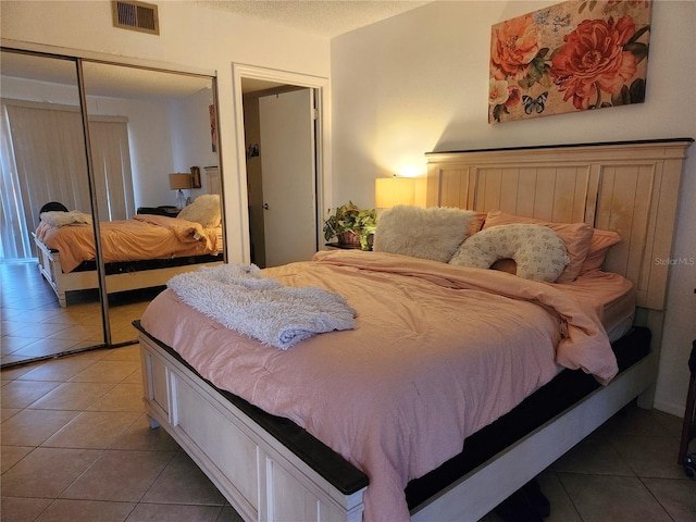 tiled bedroom with a closet