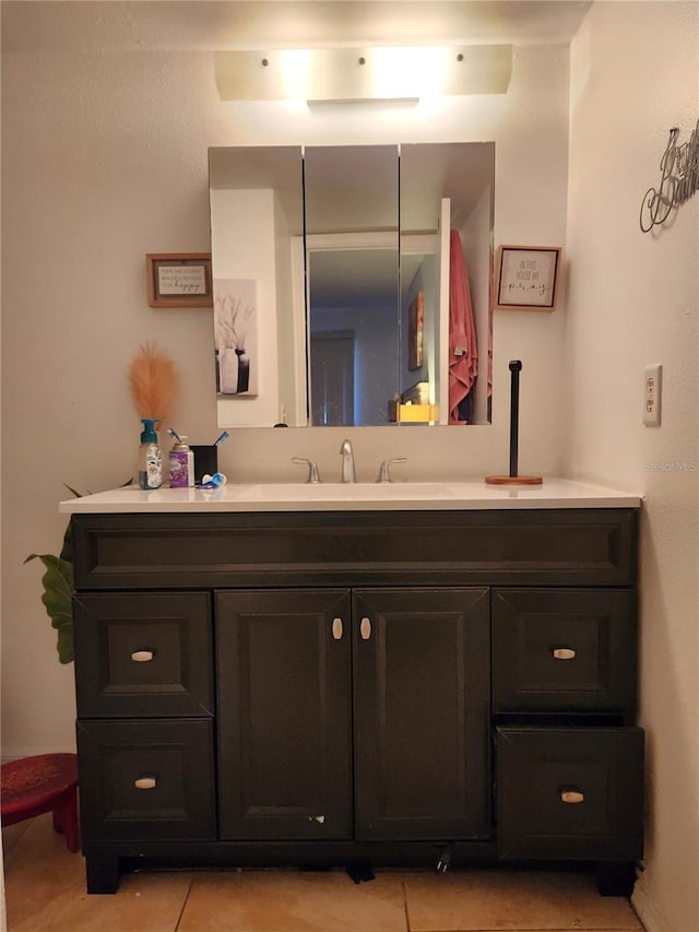 bathroom featuring tile patterned flooring and vanity