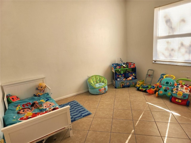 recreation room featuring plenty of natural light and light tile patterned floors