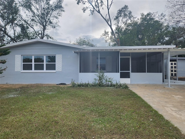 rear view of house featuring a yard