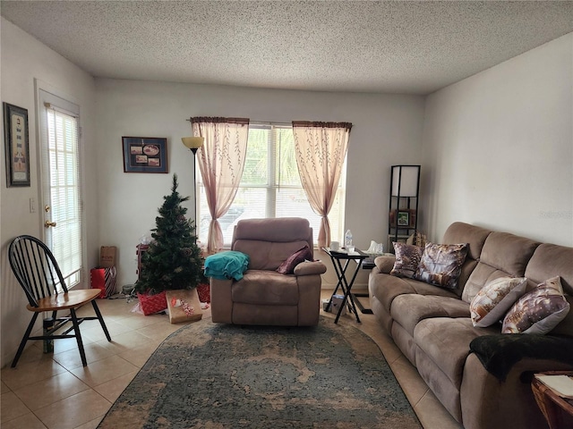 tiled living room featuring a textured ceiling