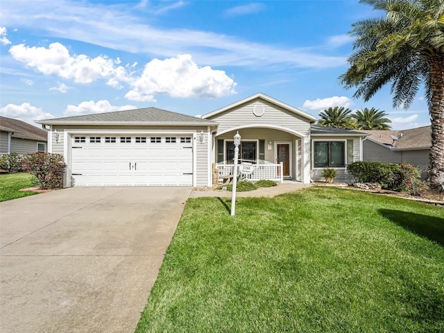 single story home with a porch, a garage, and a front yard