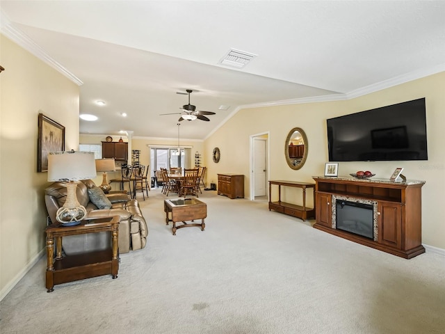 living room featuring ceiling fan, ornamental molding, vaulted ceiling, and light carpet