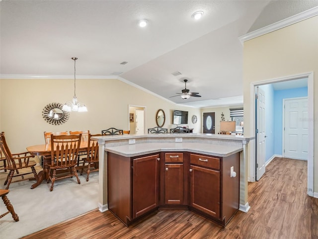 kitchen featuring dark wood-type flooring, a center island, vaulted ceiling, and pendant lighting