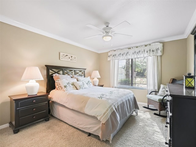 carpeted bedroom featuring ceiling fan and ornamental molding