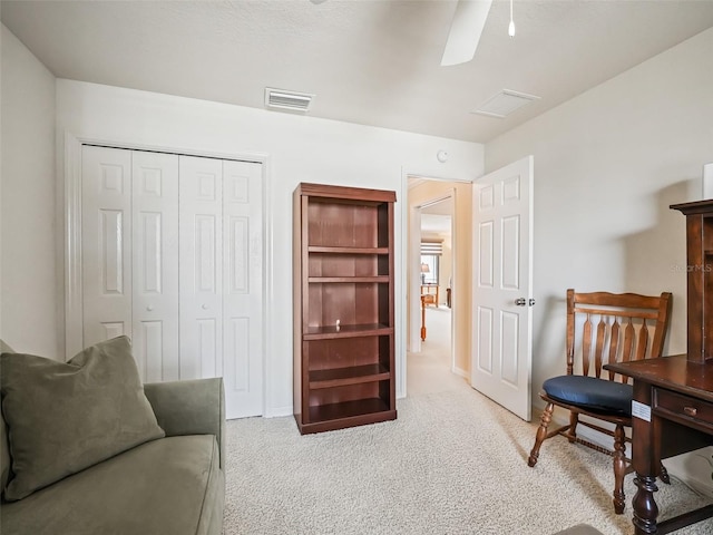 sitting room with light carpet and ceiling fan