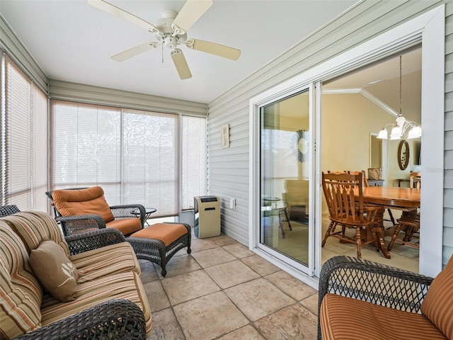 sunroom with ceiling fan with notable chandelier