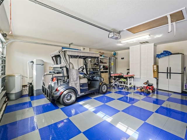 garage featuring a garage door opener and water heater