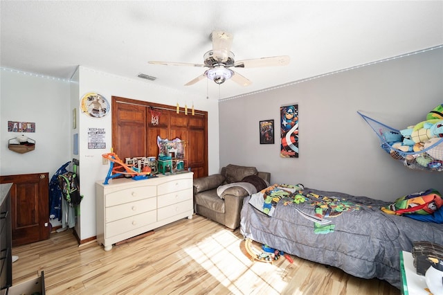 bedroom with light wood-type flooring and ceiling fan