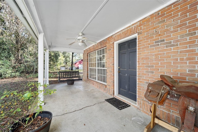 view of exterior entry featuring ceiling fan