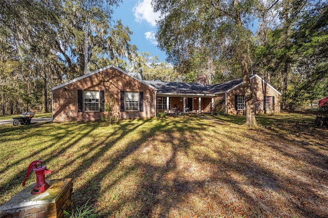 10249 NW 21st St, Ocala, FL 34482 - ranch-style home with a front lawn, a chimney, and covered porch