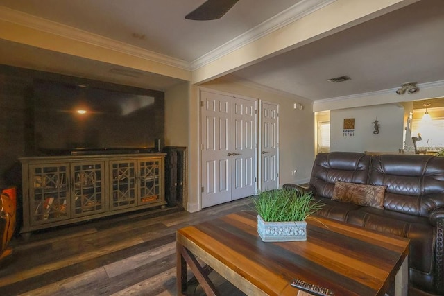 living room featuring ceiling fan, dark wood-type flooring, and crown molding