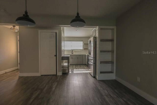 unfurnished dining area featuring dark hardwood / wood-style flooring and sink